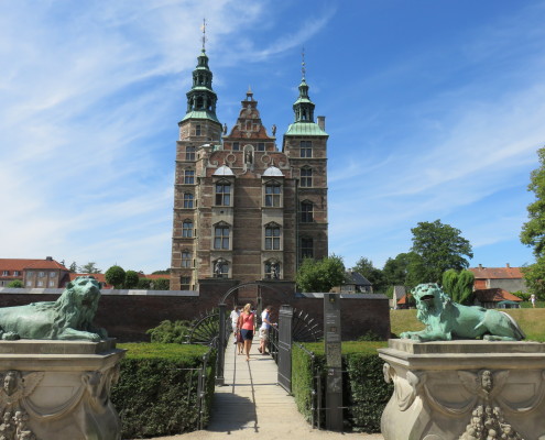 Rosenborg Castle seen from Kongens Have, Copenhagen, Denmark. There are two Lion Sculptures in the foreground
